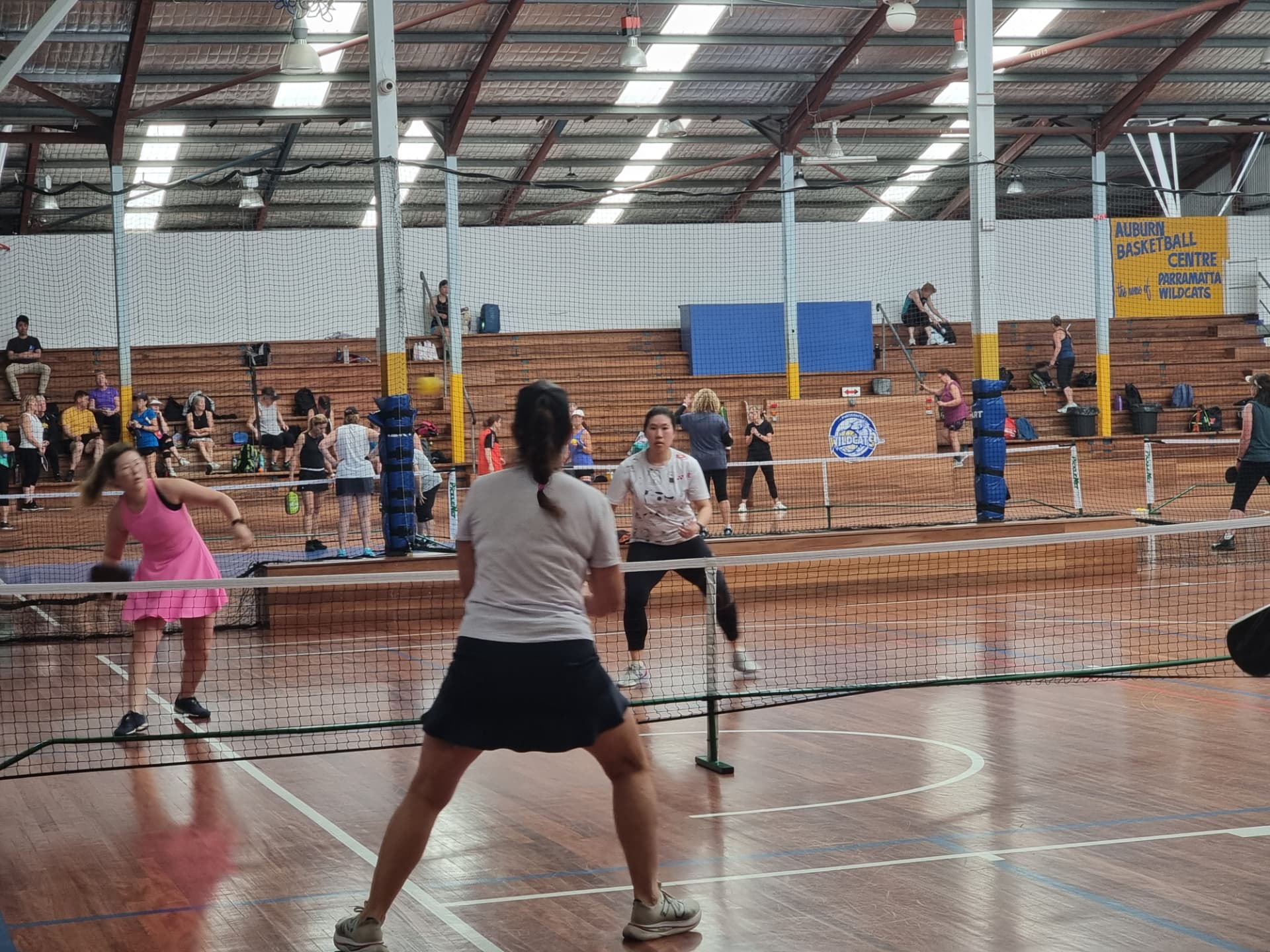Members playing across the courts during a busy club session